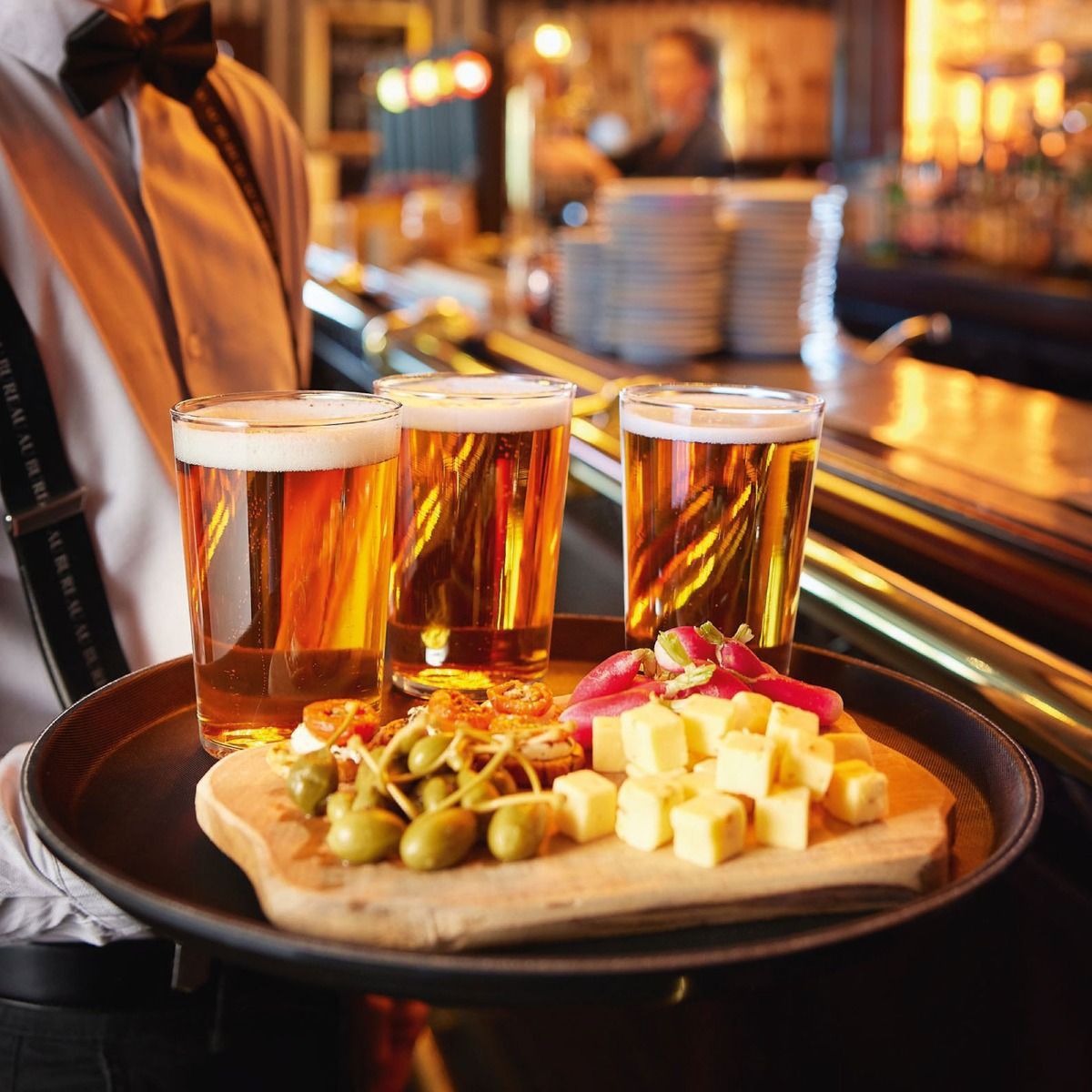 Filled Glass Conique 47 cl. with logo, placed in an atmospheric setting with warm lighting.