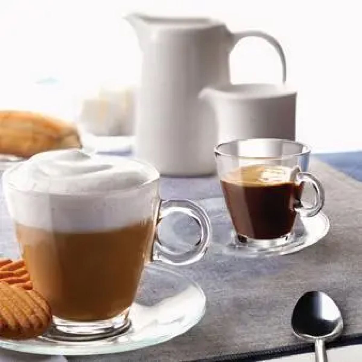 Glass cappuccino with foam and espresso in ambient room, Easy Bar 23 cl. in use.
