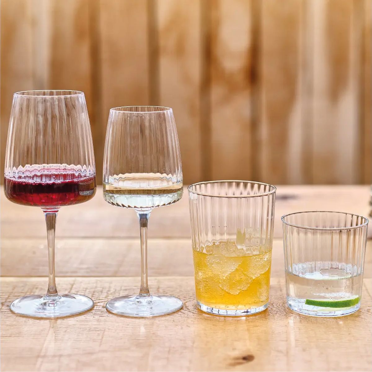 Filled Exclusiva Tumbler glass 50 cl. with logo presented in a modern ambience setting.