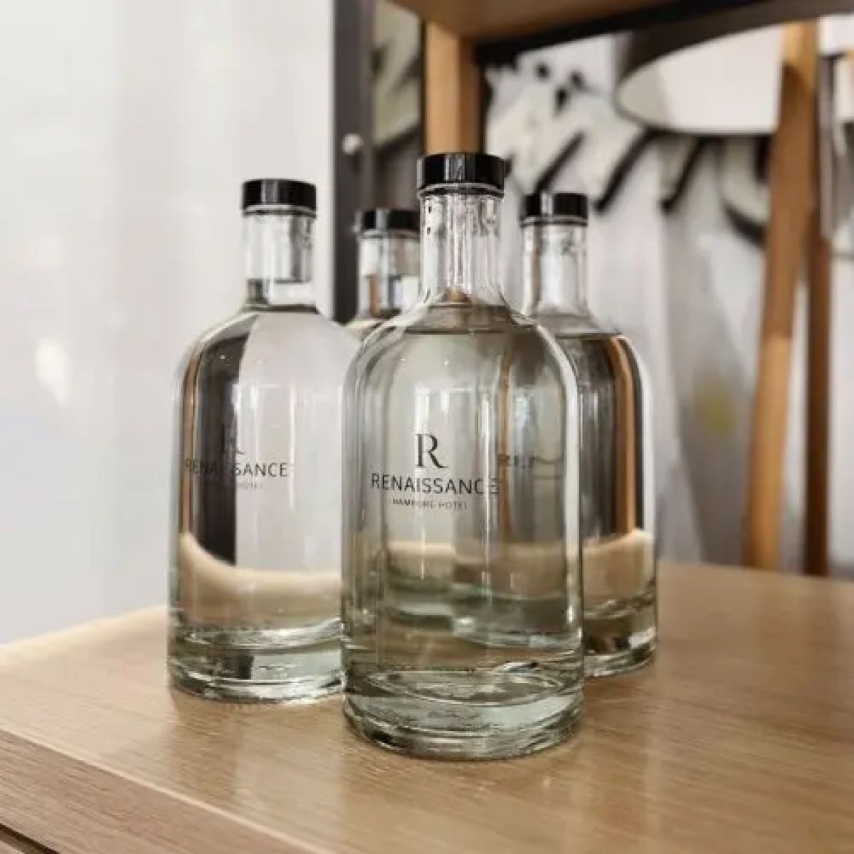 Filled Bottle Oslo 0.7 litre with printed logo placed in a decorated ambience room.