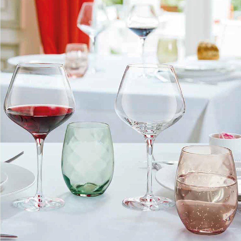 Sublym wine glass 45 cl with wine filling and visible logo, attractively presented in an interior setting.