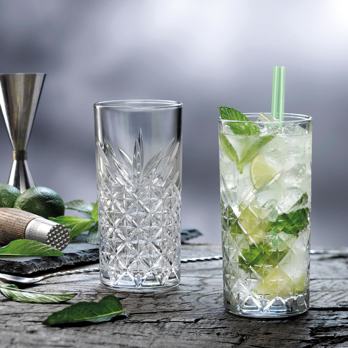 Timeless Longdrink glass 45 cl. with filling, placed in an atmospheric setting.
