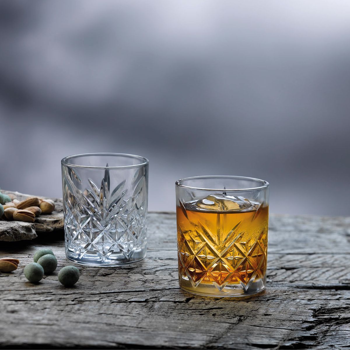 Timeless Whisky glass with whisky on wooden table in atmospheric, warm setting.